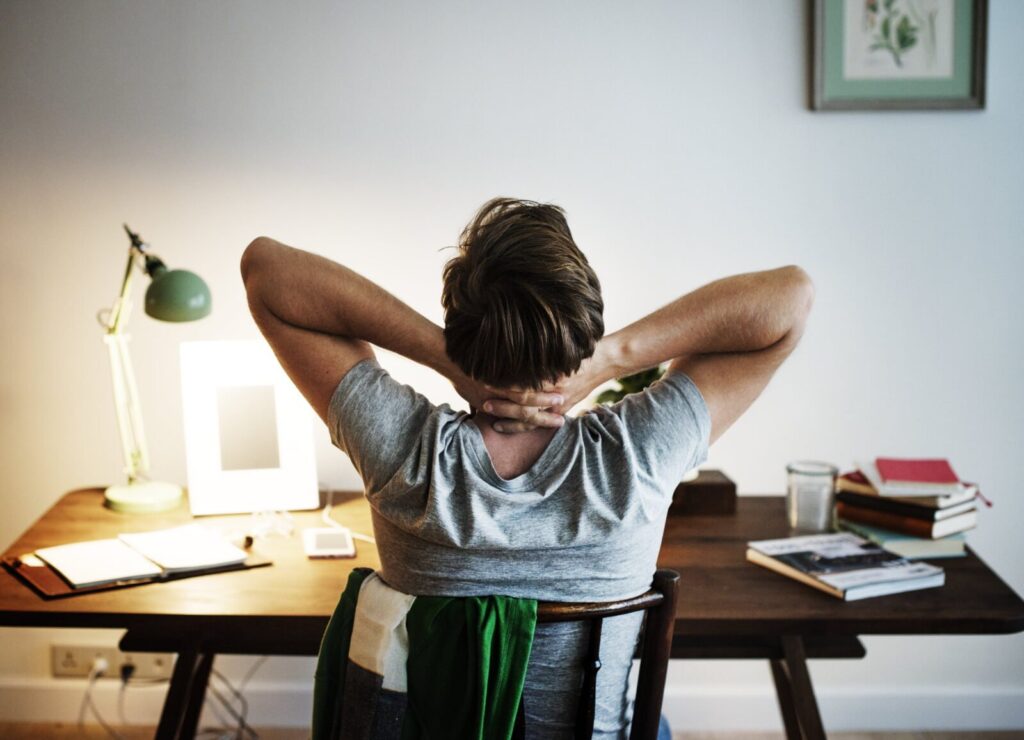 7 Reasons For A Remedial Massage Today 1 Man Stressed While Working On Laptop