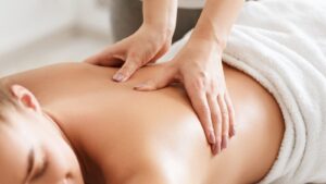 Discover Blissful Massage Near Aspley At Fullon Life 2 Body Care. Young Girl Having Massage, Relaxing In Spa Salon